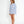 Woman wearing a light blue oversized shirt on a white background