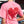 Person wearing a pink t-shirt with a red heart design outdoors